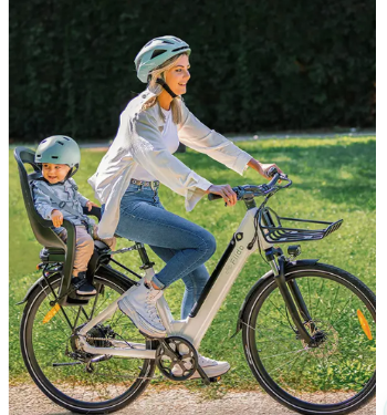 A woman touring with her son while riding an e-bike she bought with a discount code