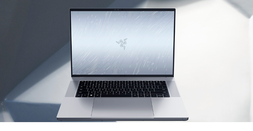 Razer laptop in a silver grey color and black keypad with the screen showing Razer logo