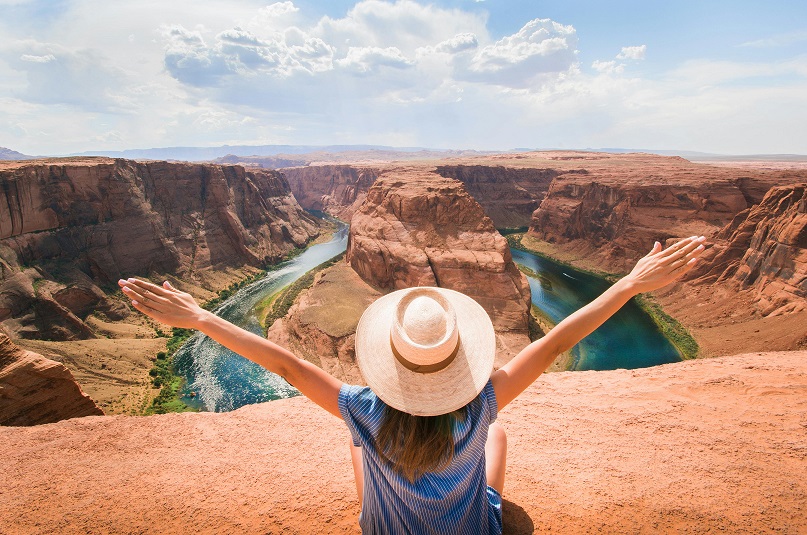 image showing a carefree woman on a solo holiday that she booked with a Travel Department discount code