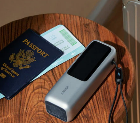 An Anker Prime Power Bank next to a passport