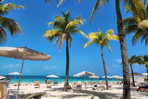 People enjoying a beach front on a holiday they booked and saved on with a Jet2holidays discount code