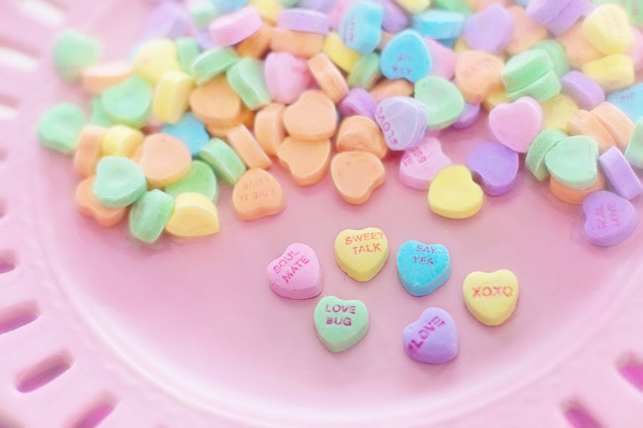 Heart sweets of different colours that have messages about love on them