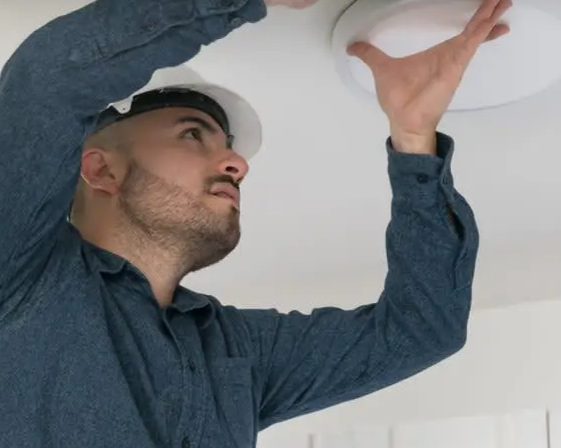 A person fixing a bulb