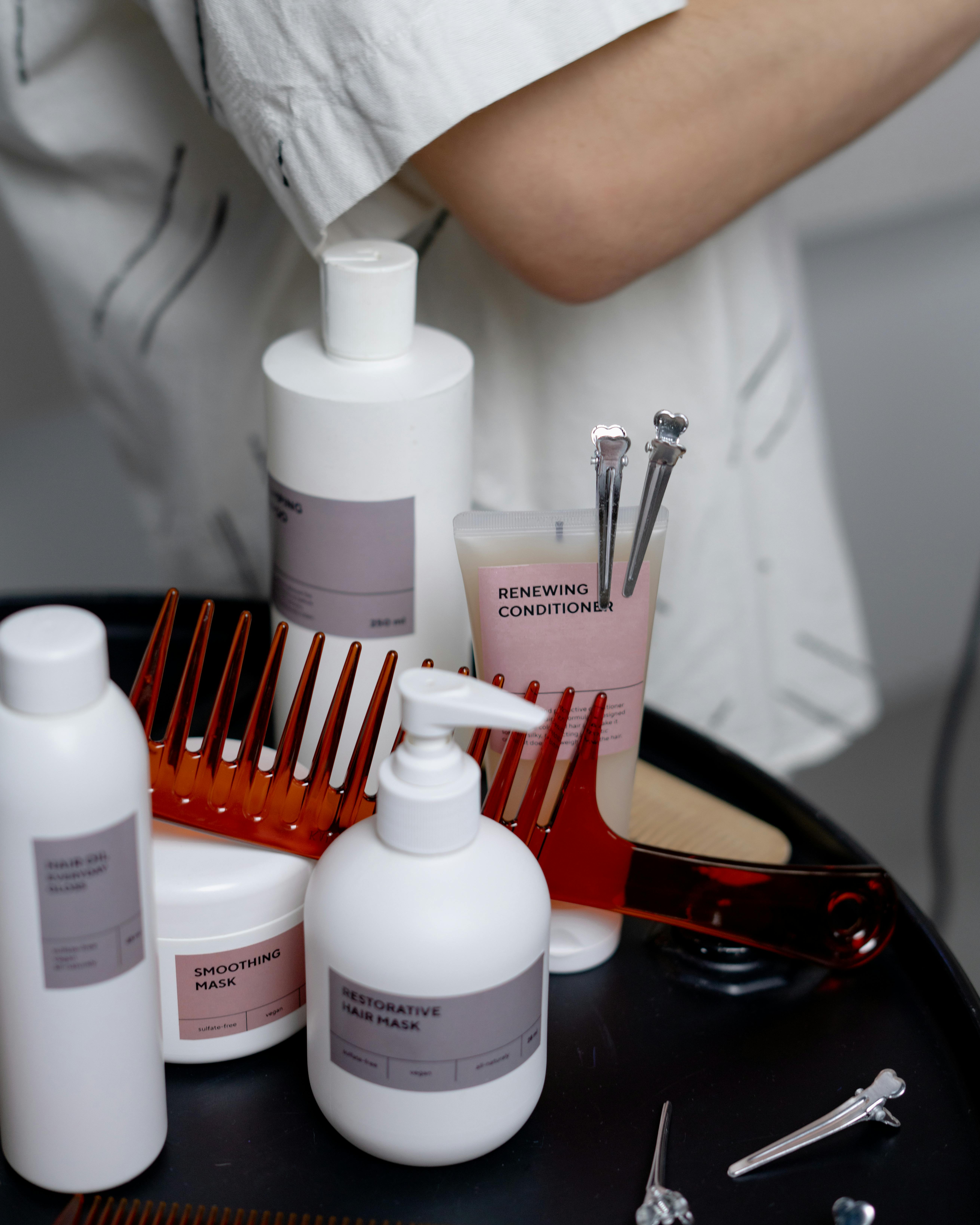 A wide range of hair care products and accessories on a table.