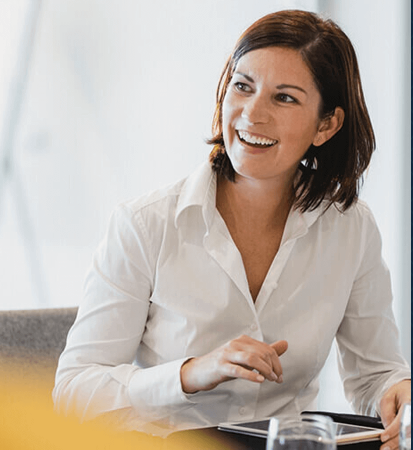 A female business owner scrolling on her iPad for affordable Kingsbridge insurance plans