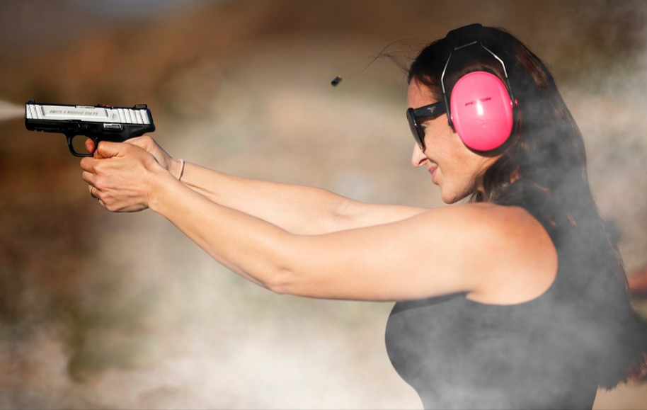 woman shooting with a handgun purchased with a Palmetto State Armory promo code