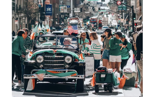 A group of people enjoying a parade on St. Patrick's Day