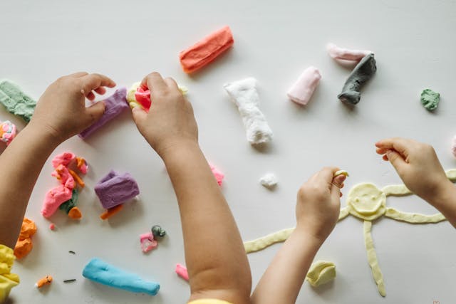 Activities for Father's Day: Two little children playing with clay