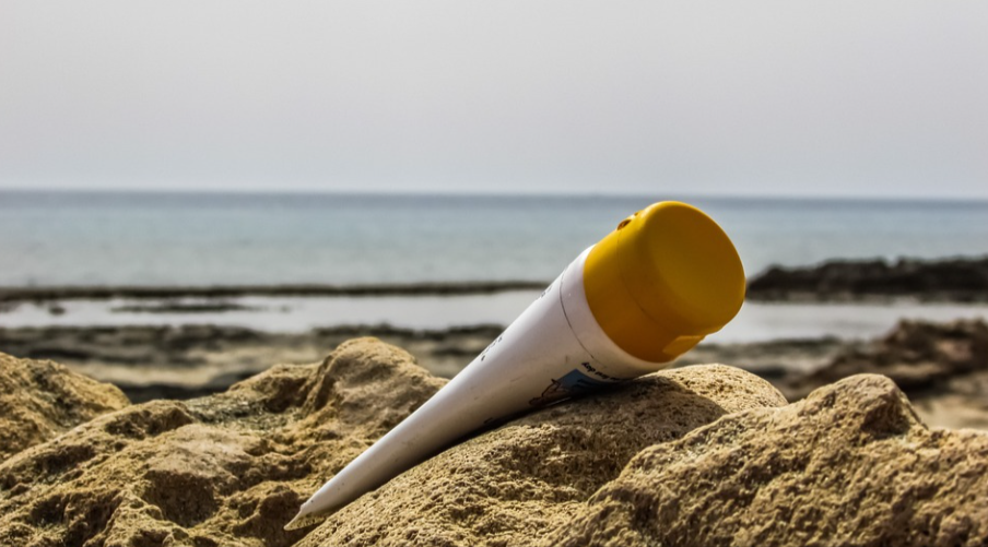 ISDIN sunscreen on the sand at the beach