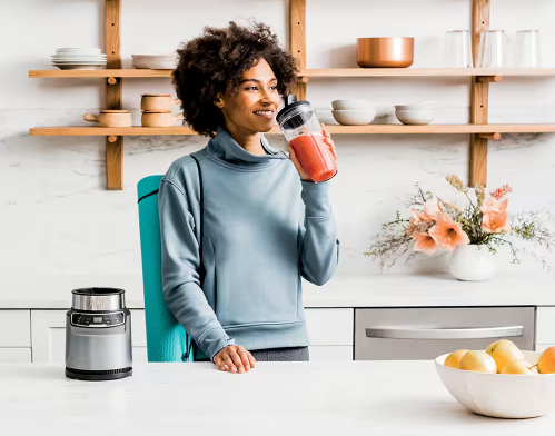 A lady enjoying a refreshing nutritious smoothie made with the nutri ninja blender recipes
