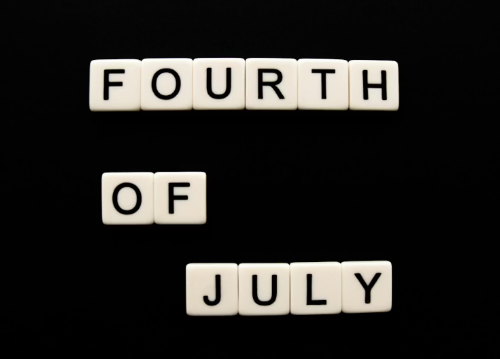 A 4th July Deals signage in black and white showing the popular sale