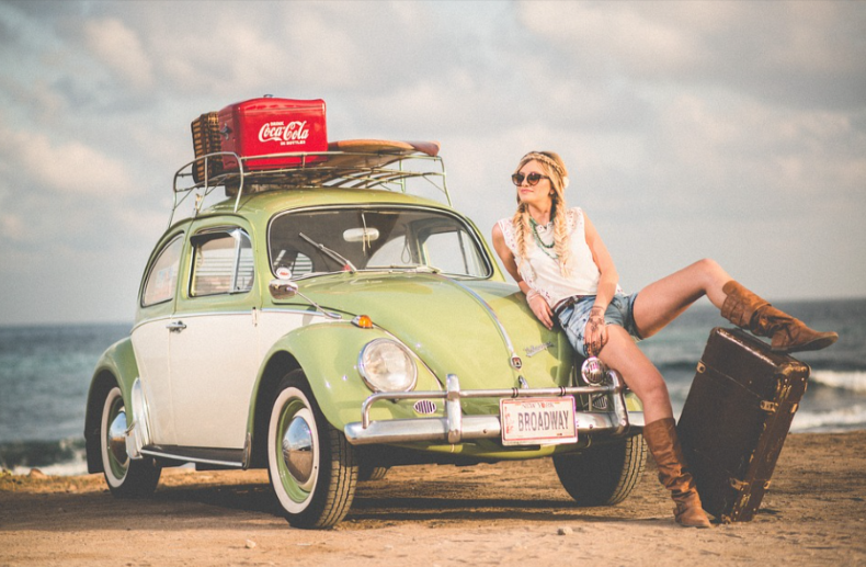 girl posing by a car after using a FINN auto discount
