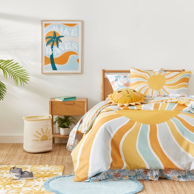 bed, bedside table & laundry basket resting on a hardwood floor with a painting on the wall