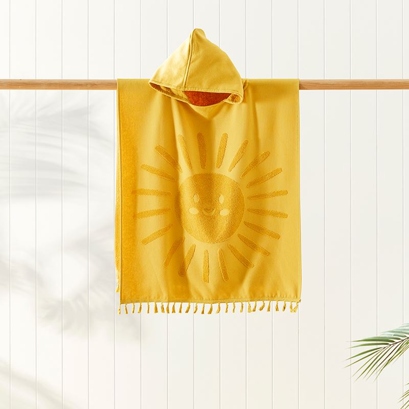 yellow towel hanging on a wooden dowel with a white paneled background