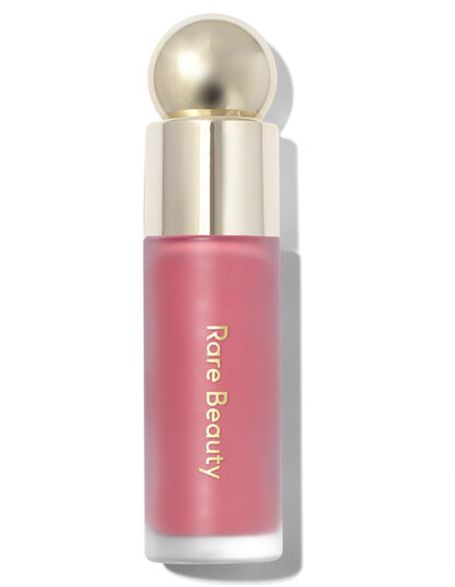 A bottle of rare beauty soft pinch liquid blush in red with a  gold cap