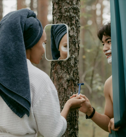 Man and woman Looking at each other while the man shaves