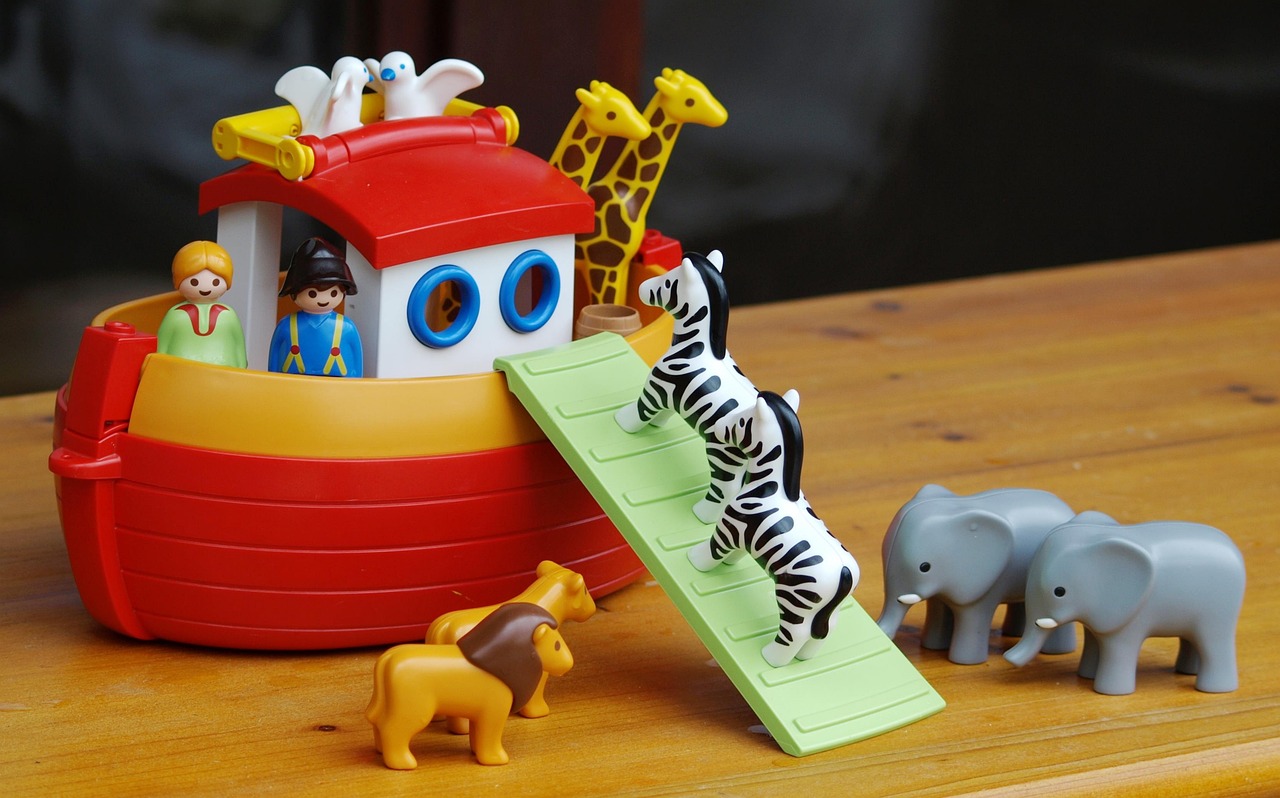 A toy of Noah’s Ark with different animals and people on the ark.