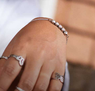 A lady wearing a Crazy Factory bracelet and Crazy Factory rings