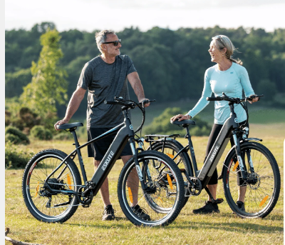 A couple catching up, while riding their electric bikes outdoors