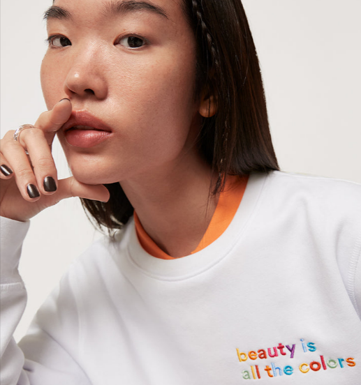 A woman wearing a 3INA organic cotton sweater 