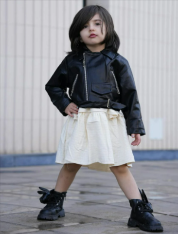 Fashionable child in black jacket and boots from BSTN