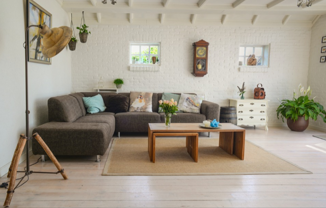 Open room space with a couch and a table and home essentials