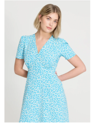 A woman wearing a floral Finery summer dress purchased with a promo code