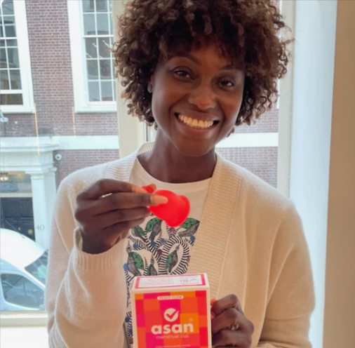 A middle aged woman holding the Asan menstrual cup