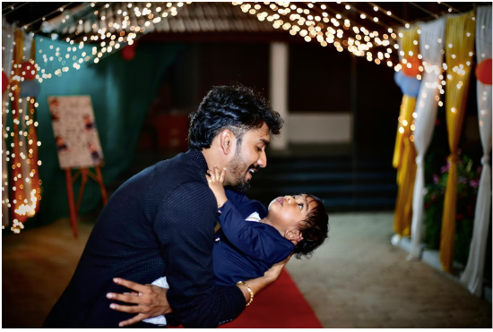 A dad holding his son at a Father's Day celebration