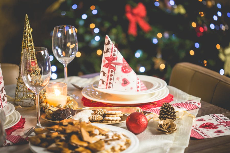 Food set out on the table with a christmas tree in the background