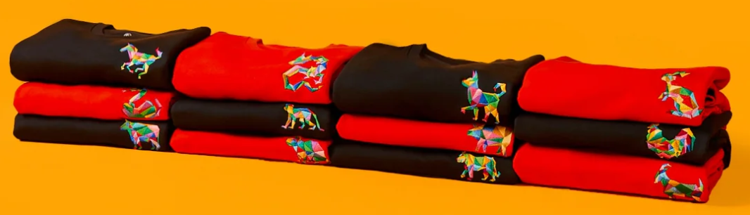 Amea black and red jumpers folded in piles on a mustard background
