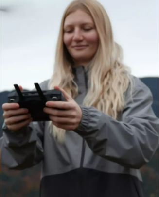 A lady operating a drone in the mountains from Ebuyer.com