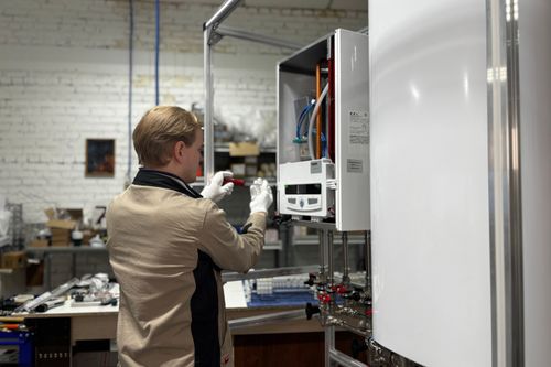 A technician from Heatable installing a boiler that somene saved on with a Heatable discount code