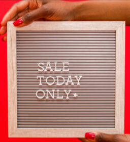 A lady showing a Black Friday sale only sign