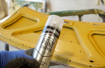 Applying a Jenolite paint stripper in a workshop
