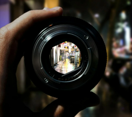 Person Holding Black Camera Lens