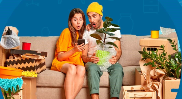A woman and a man sitting on a couch looking into a phone with shocked faces