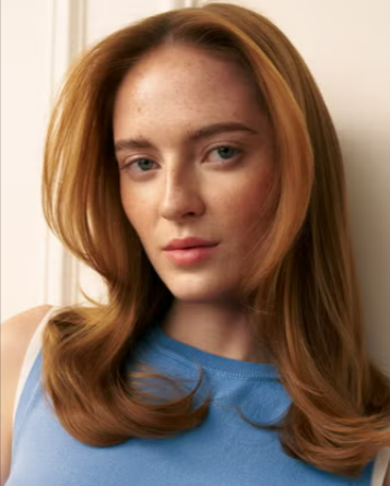 A woman with ginger hair that maintains her hair with Christophe Robin