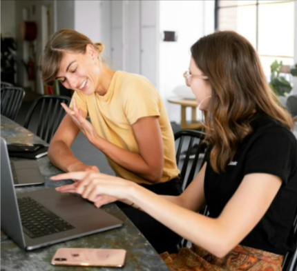 Two women having a conversation and shopping on the Boots website