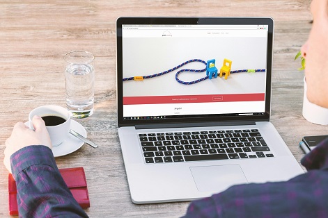 image showing a laptop and someone using it 