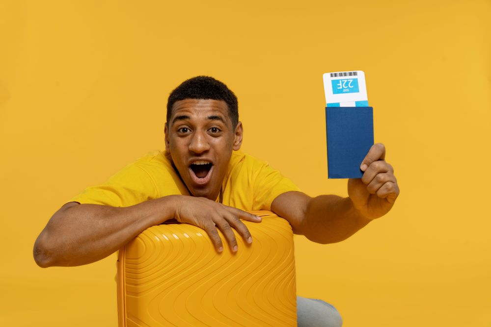 medium-shot-man-holding-passport on a mustard background