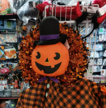 Colorful Halloween pumpkin decoration in an indoor costume shop.