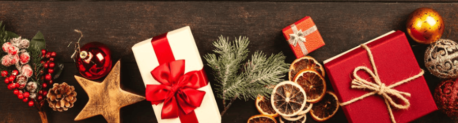 Christmas decor on a brown rustic background showcasing baubles, gifts, dried lemons and Christmas stars