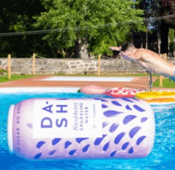 A Dash Water floatie in a pool and a person jumping in the pool