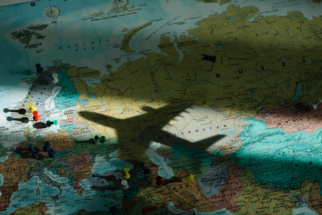Things to do over Easter: Shadow of an aeroplane on a map of the world
