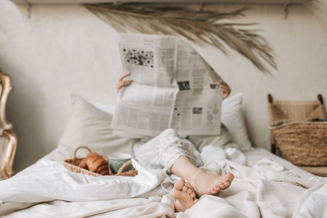 Ireland Staycations: A person sitting in bed with a newspaper
