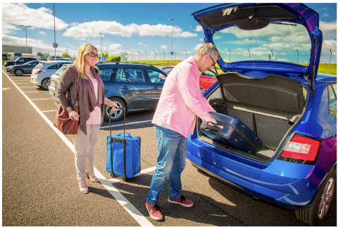 A couple offloading their bags and going to catch a flight