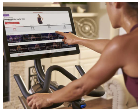 A woman doing a workout on the smart bicycle