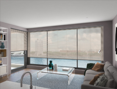 A living room furnished with a couch, glass coffee table, and a white shelf unit