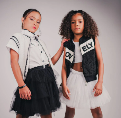 Fashion forward children wearing items from Diesel posing in studio
